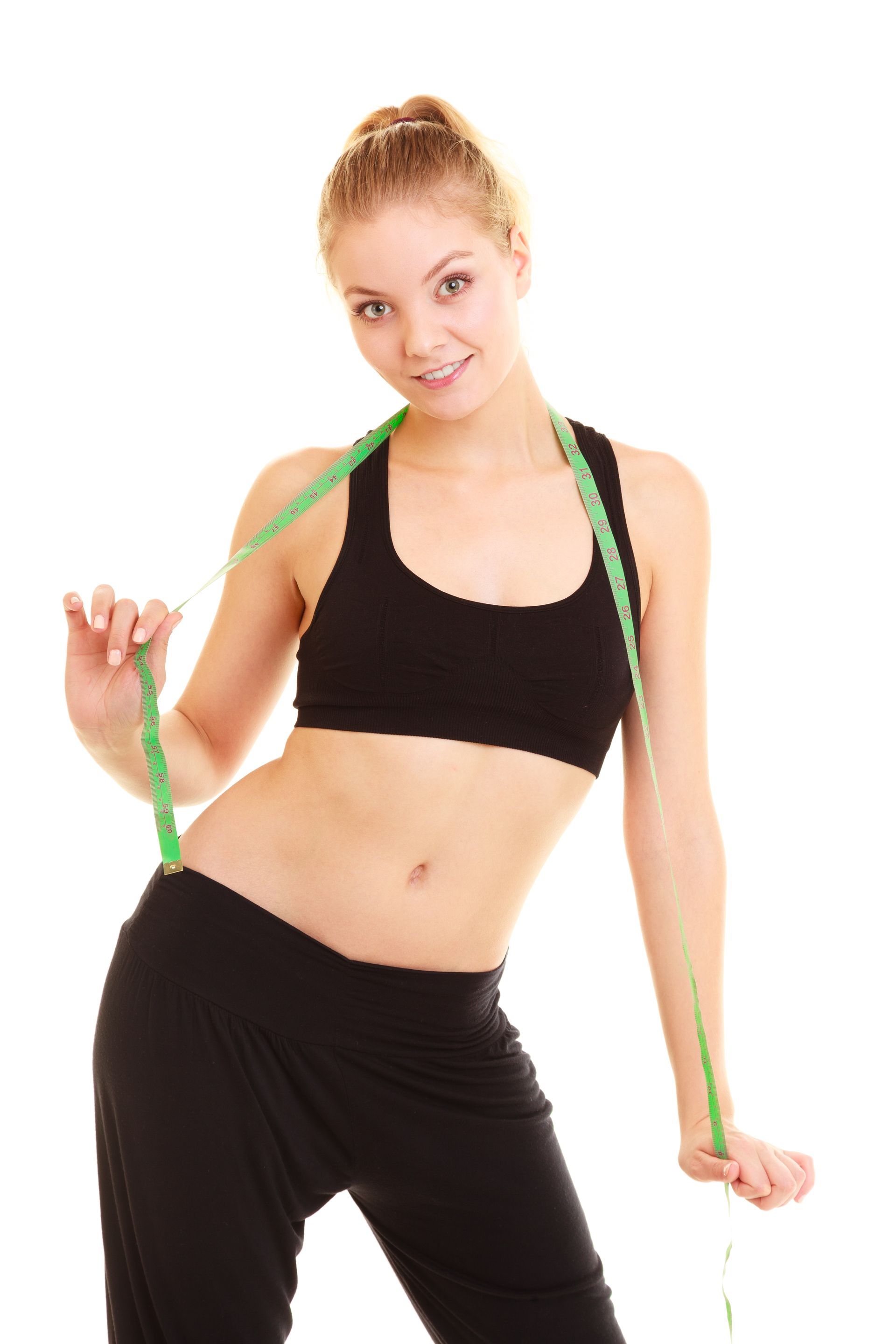 Woman in workout clothes with a measuring tape around her neck, smiling at the camera.