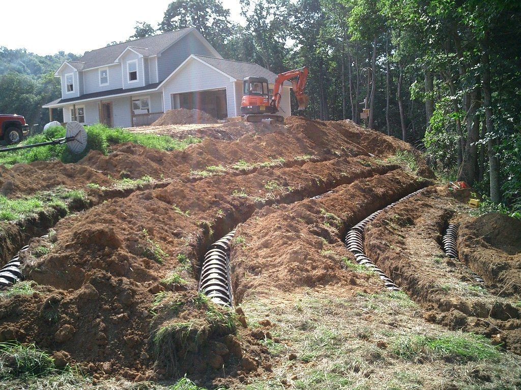 A construction worker is working on a concrete wall.