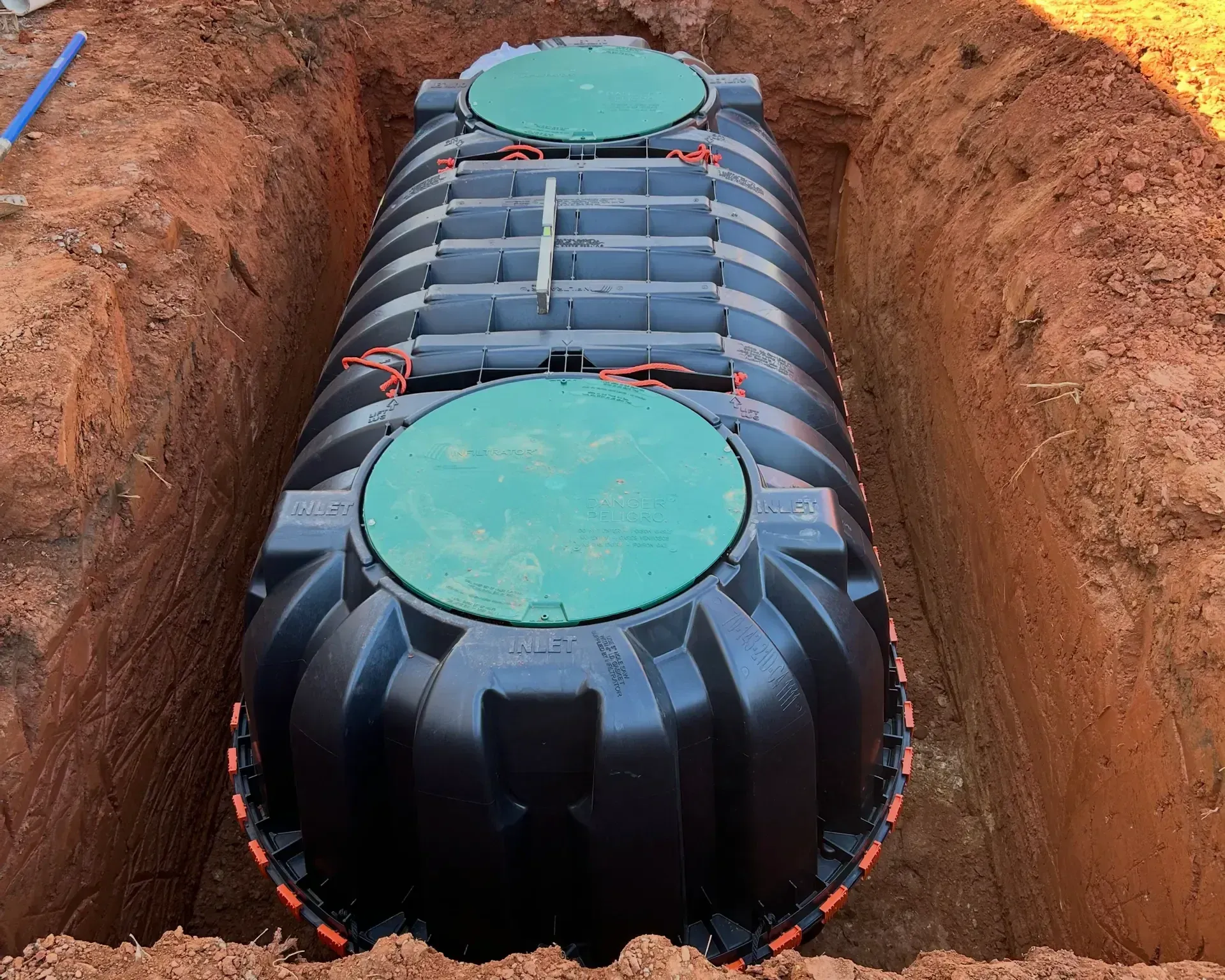 A man wearing gloves is working on a stone wall.