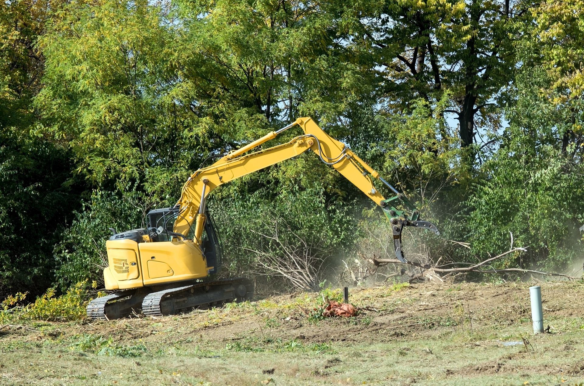 A man wearing gloves is working on a stone wall.