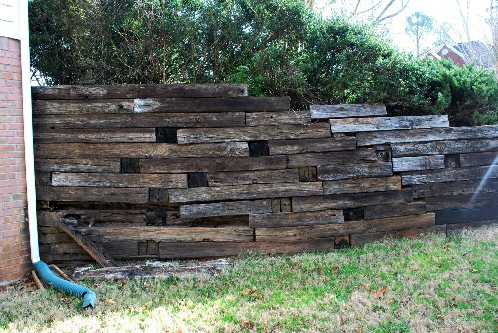 A construction worker is working on a concrete wall.