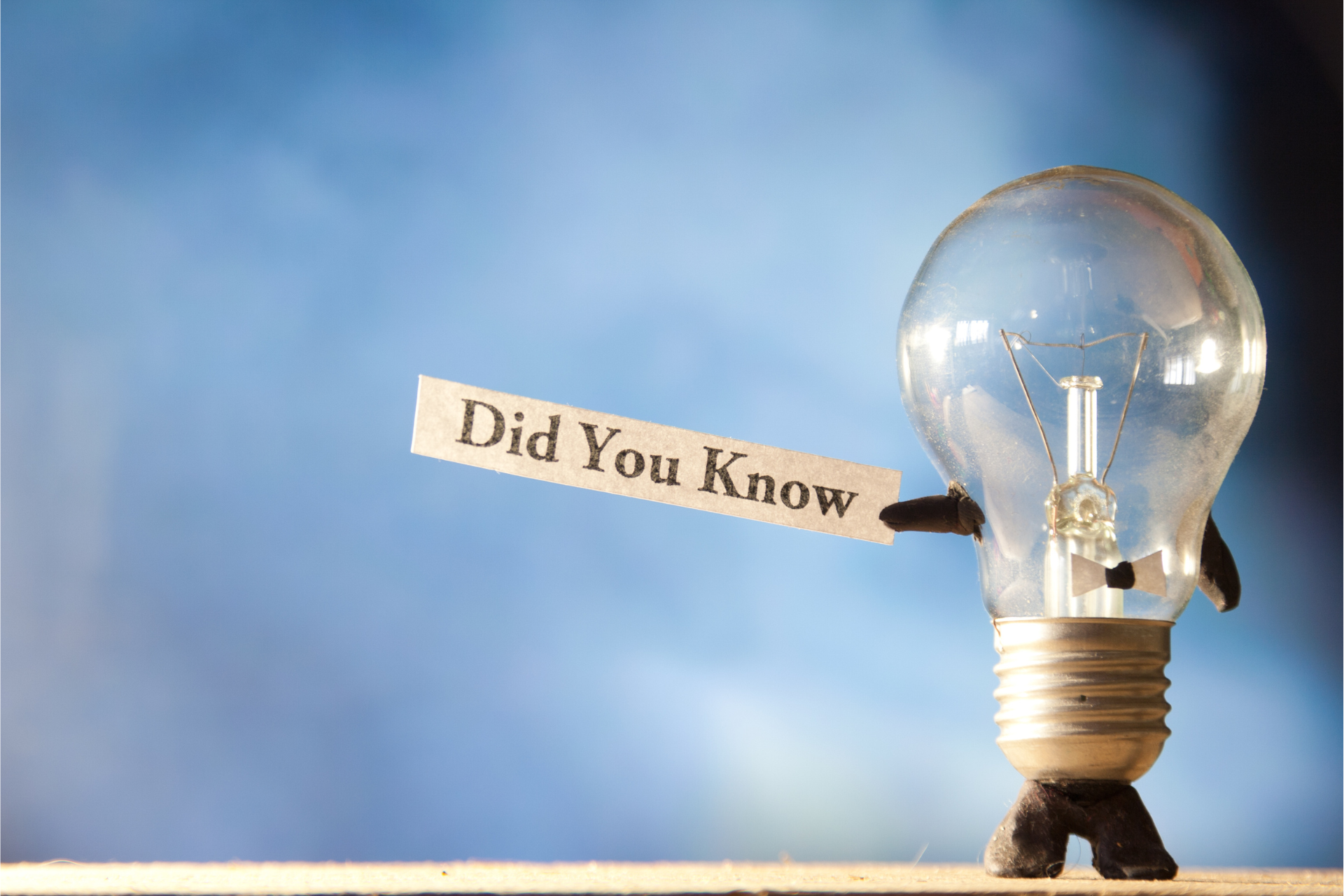 A light bulb with arms and legs is holding a sign that says did you know.