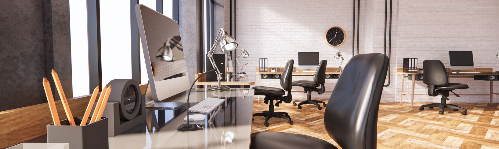 An office with a lot of desks and chairs and a clock on the wall.
