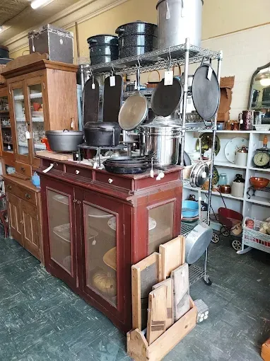 A room filled with lots of pots and pans on shelves.