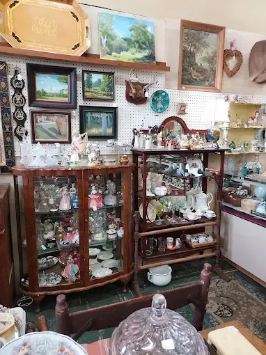 A room filled with lots of antique items and paintings.