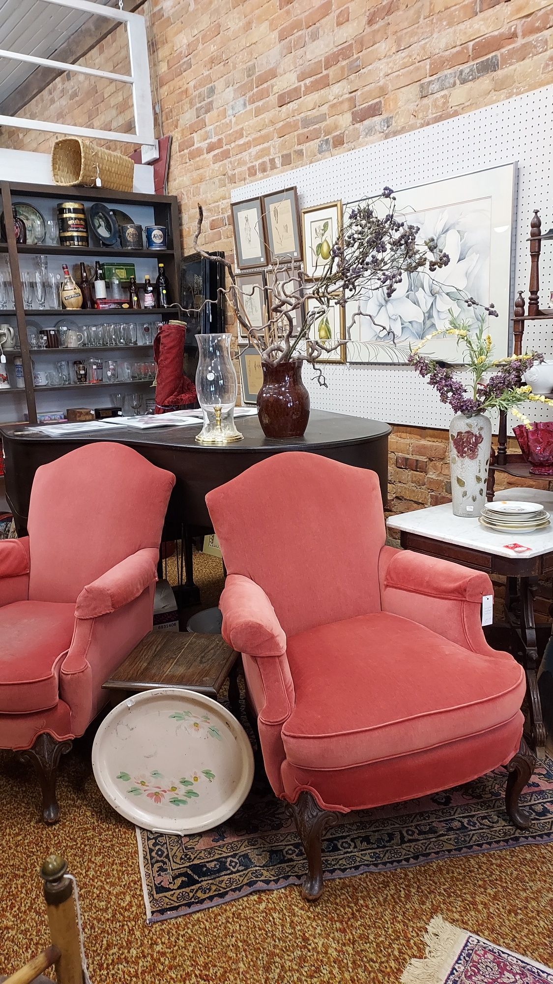 A white wicker couch with a blue cushion is sitting on a patio next to a yellow chair.