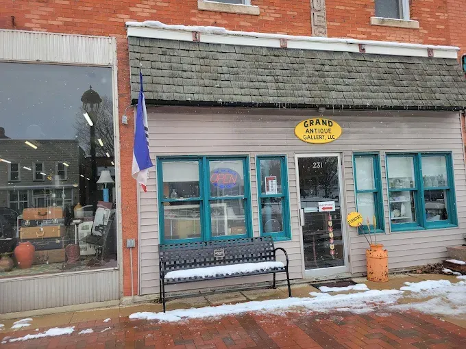 A store front with a blue bench in front of it
