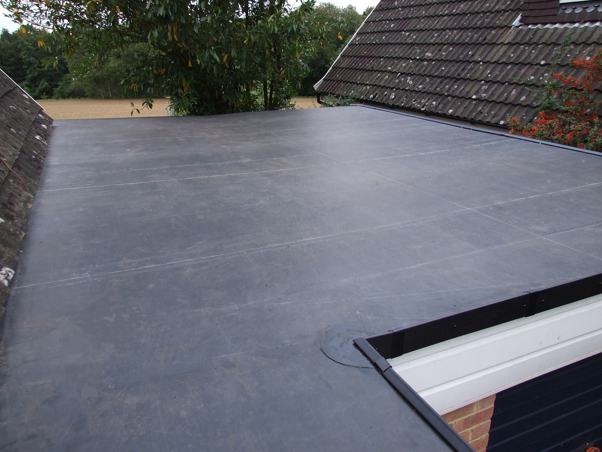 A roof with a black roofing material on it