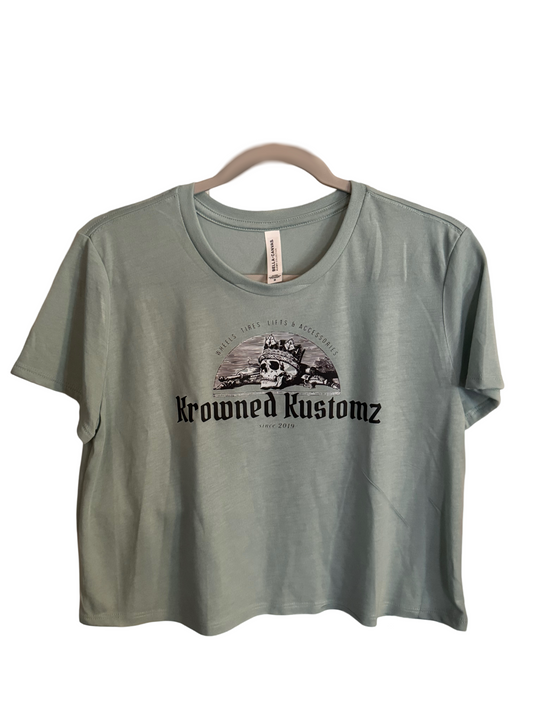 A t-shirt is hanging on a hanger on a white background.