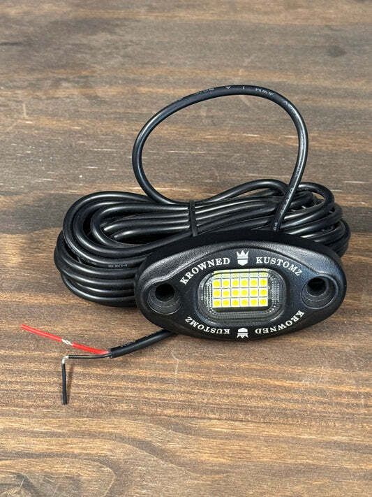 A light is sitting on top of a wooden table.