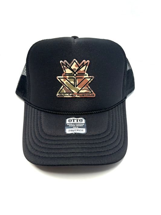 A black trucker hat with a gold crown on it