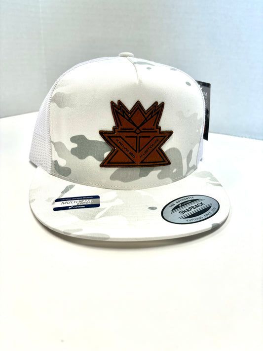 A white hat with a crown on it is sitting on a white table.