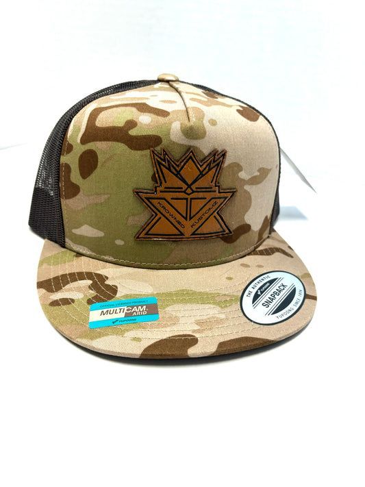A camouflage hat with a crown on it