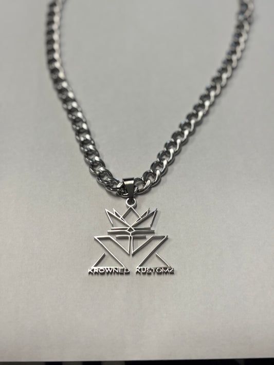 A close up of a necklace with a pendant on it