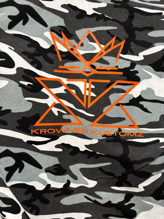 A black and white camouflage pattern with an orange crown on it