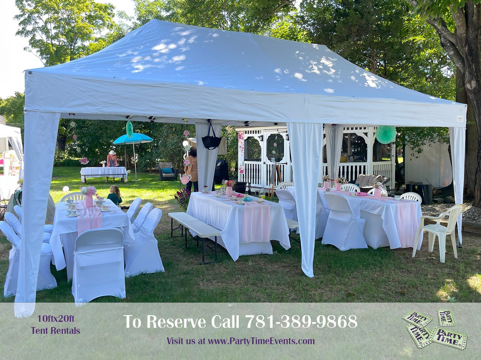 A white tent with tables and chairs underneath it