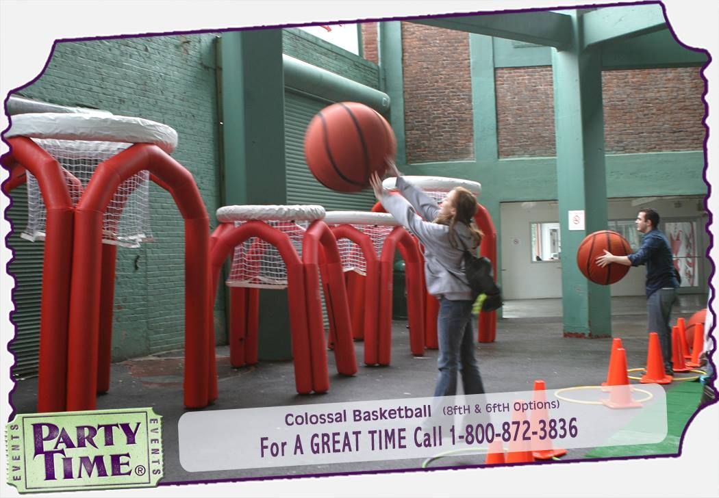 A girl is holding a basketball in front of a sign that says party time