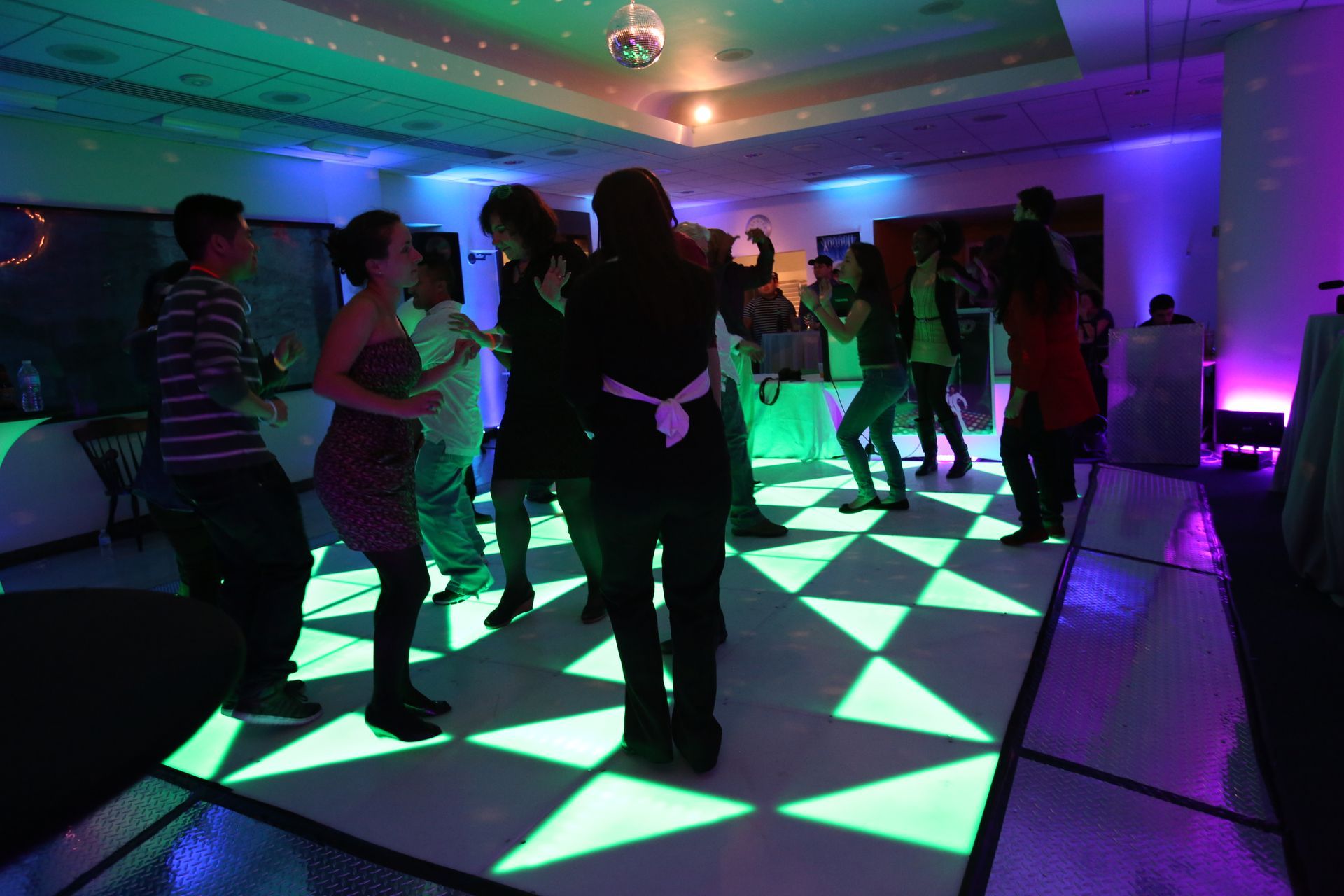 A group of people are dancing on a dance floor.