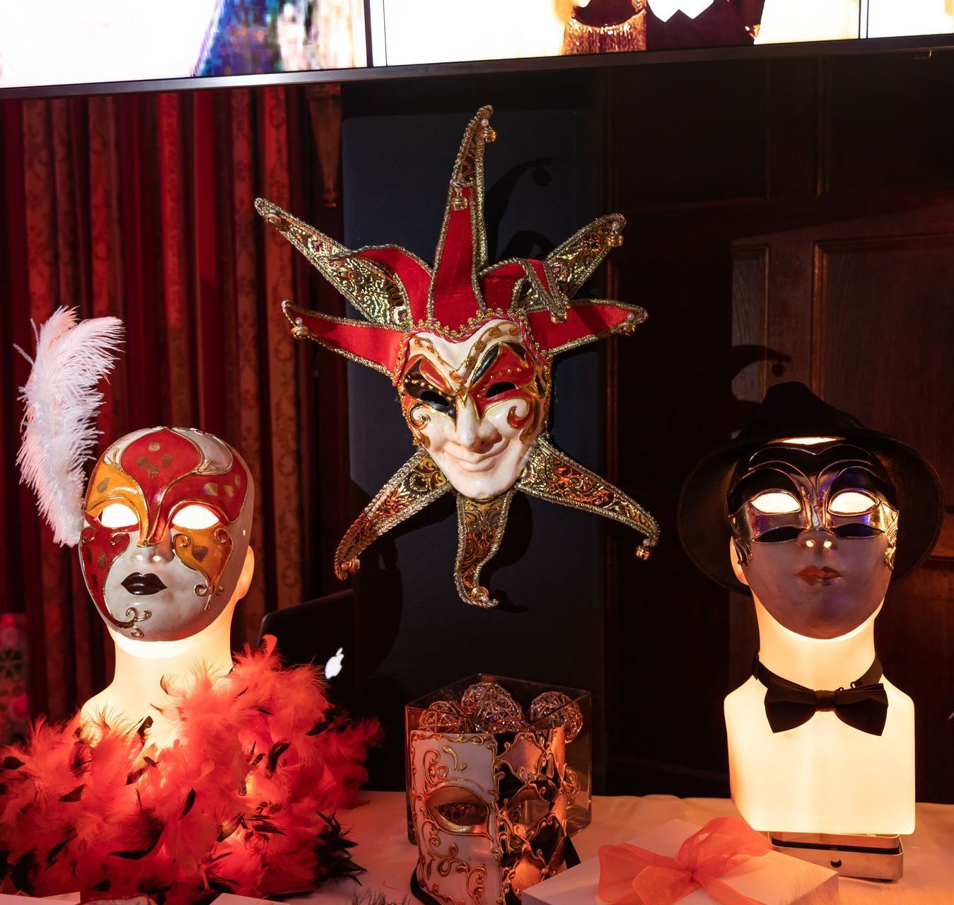 A display of carnival masks including a jester mask