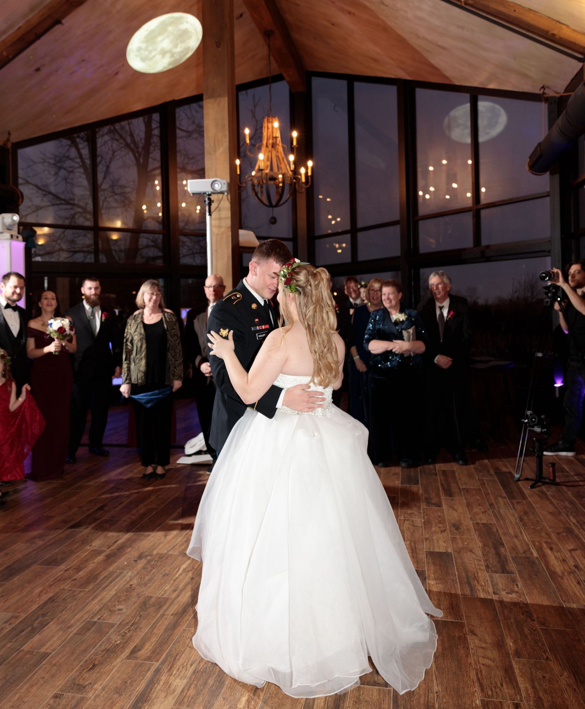 A bride and groom are dancing at their wedding reception