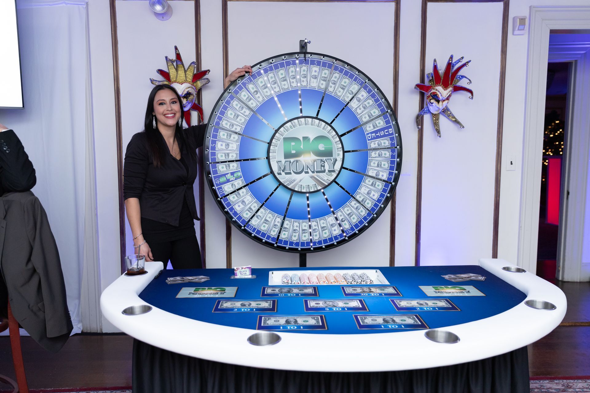 A woman is standing in front of a roulette wheel.