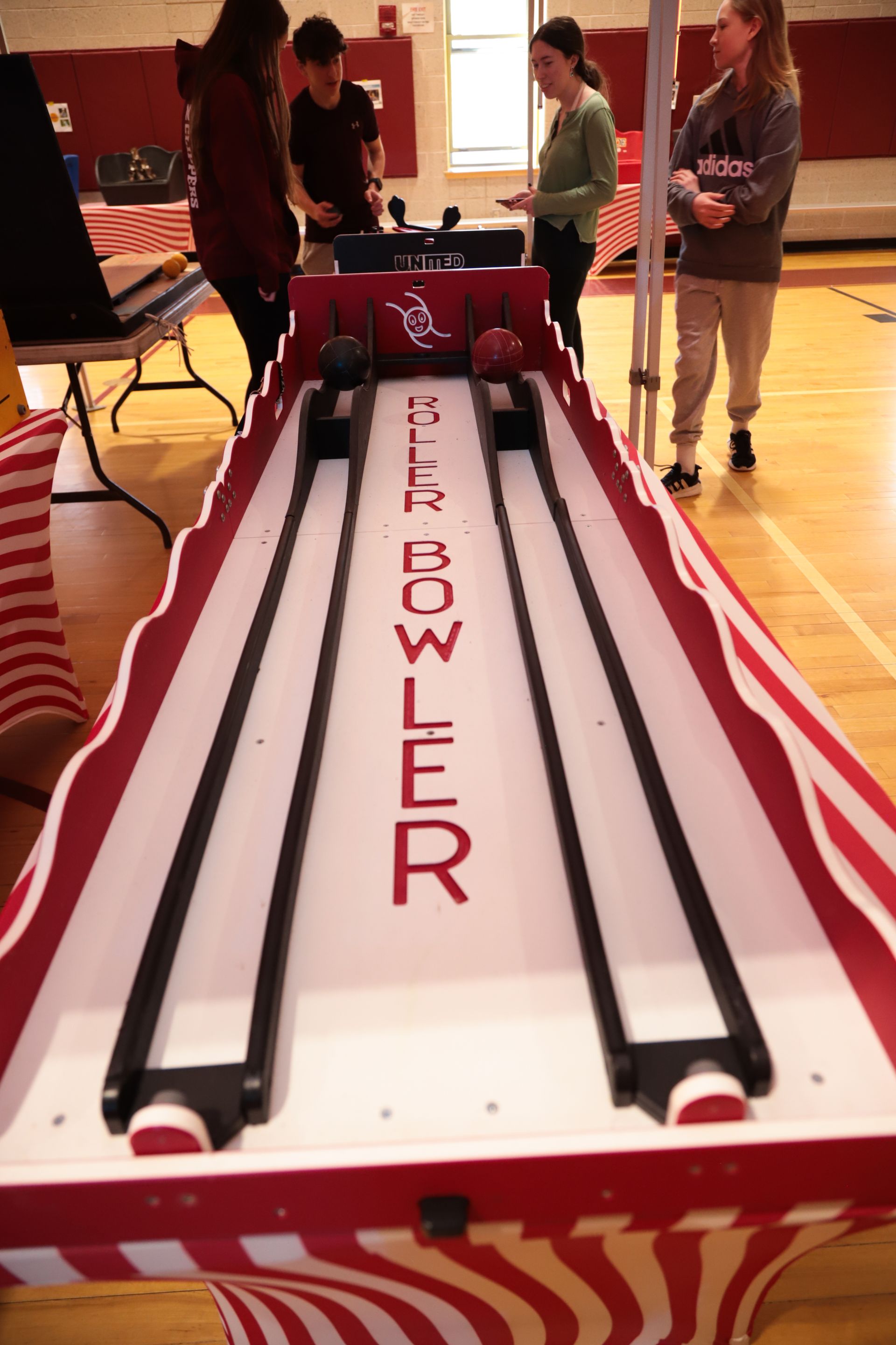A bear bowler game is being played in a gym