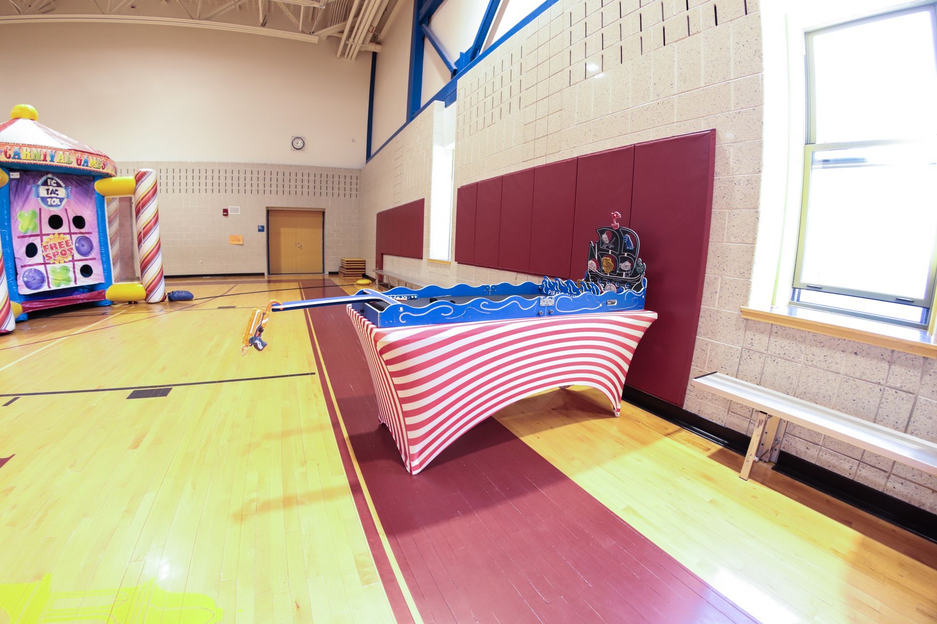 An empty gym with a table and a bouncy house