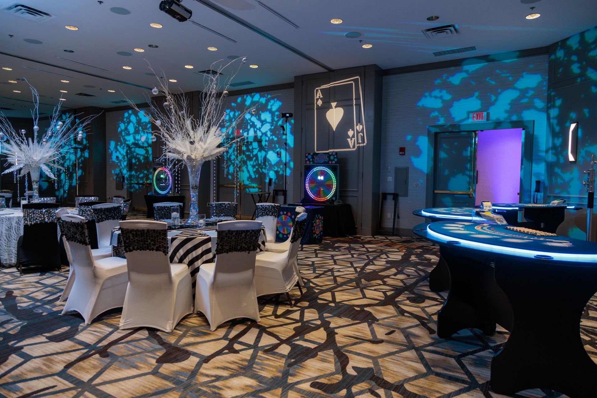 A large room with tables and chairs set up for a party.