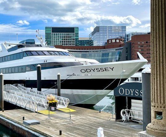 A large boat is docked at a dock in a city.