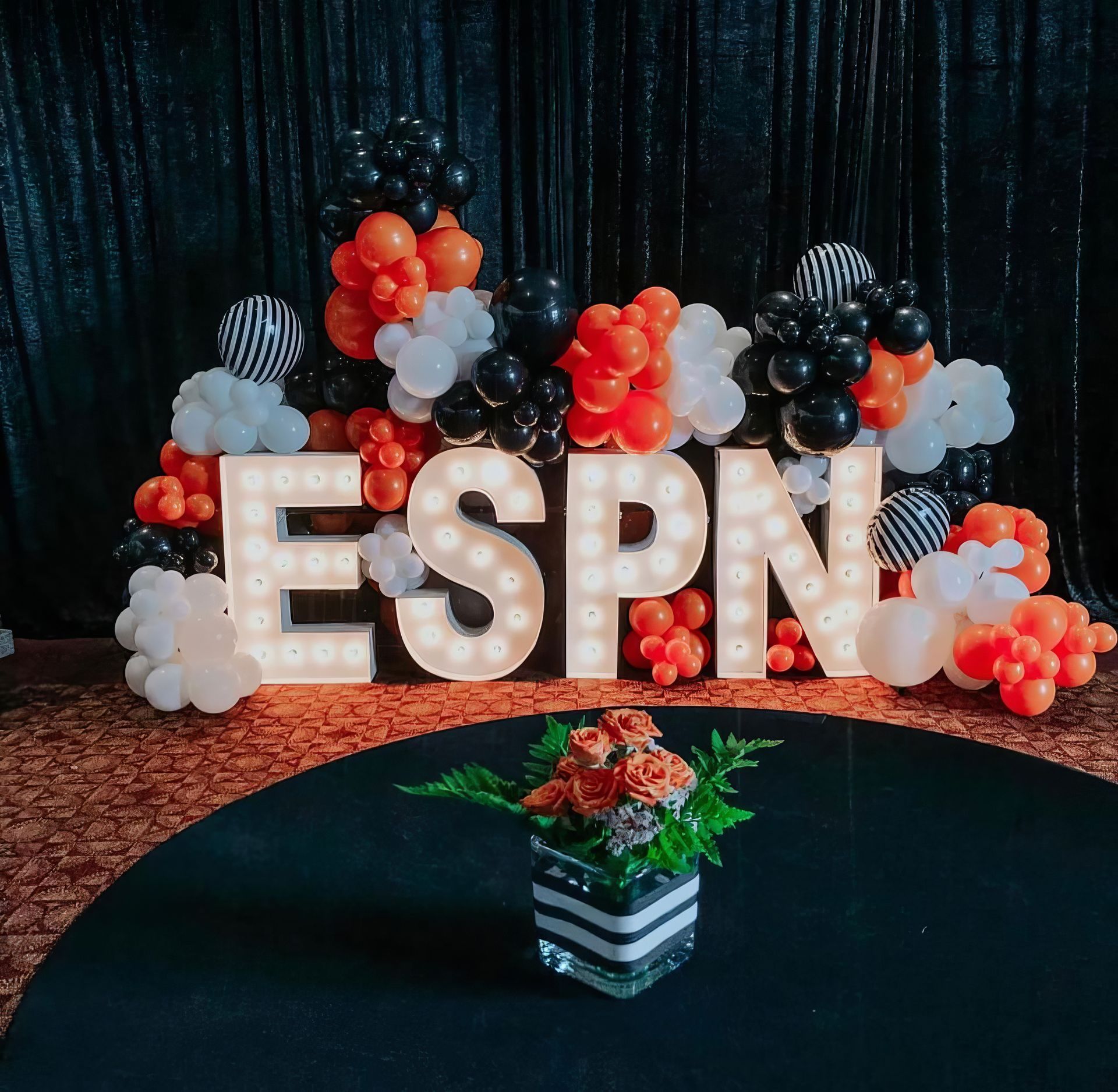 A large group of people are dancing at a wedding reception.