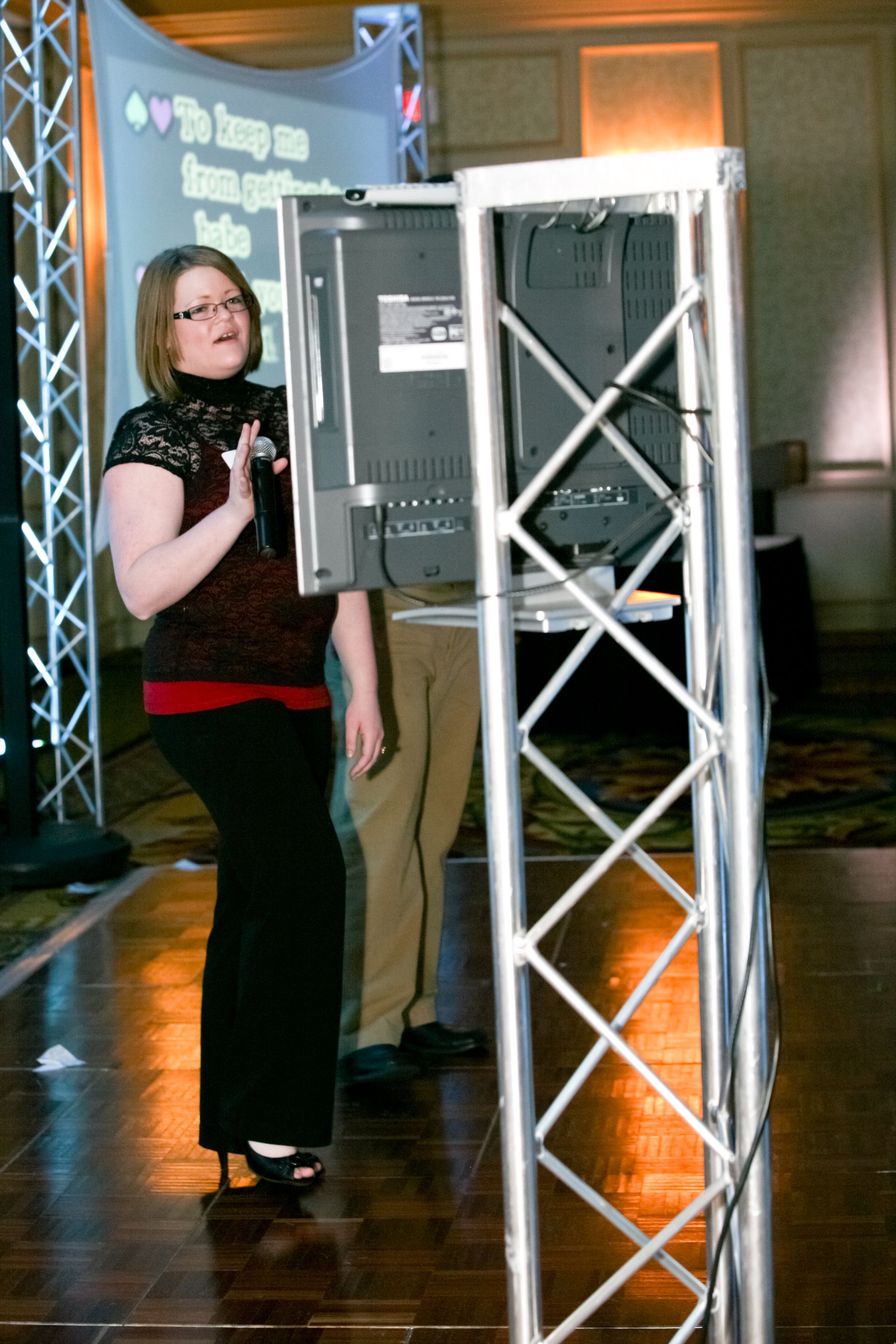 A woman stands in front of a screen that says the image on