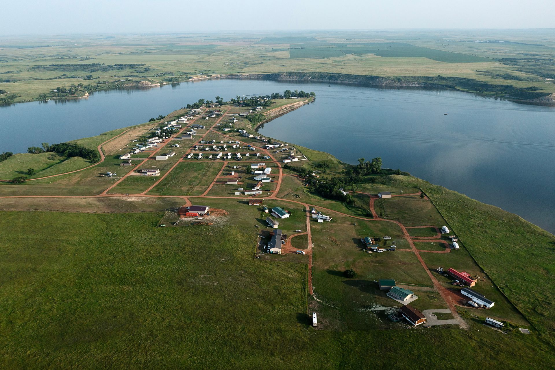 An aerial view of a small town on the shore of a lake