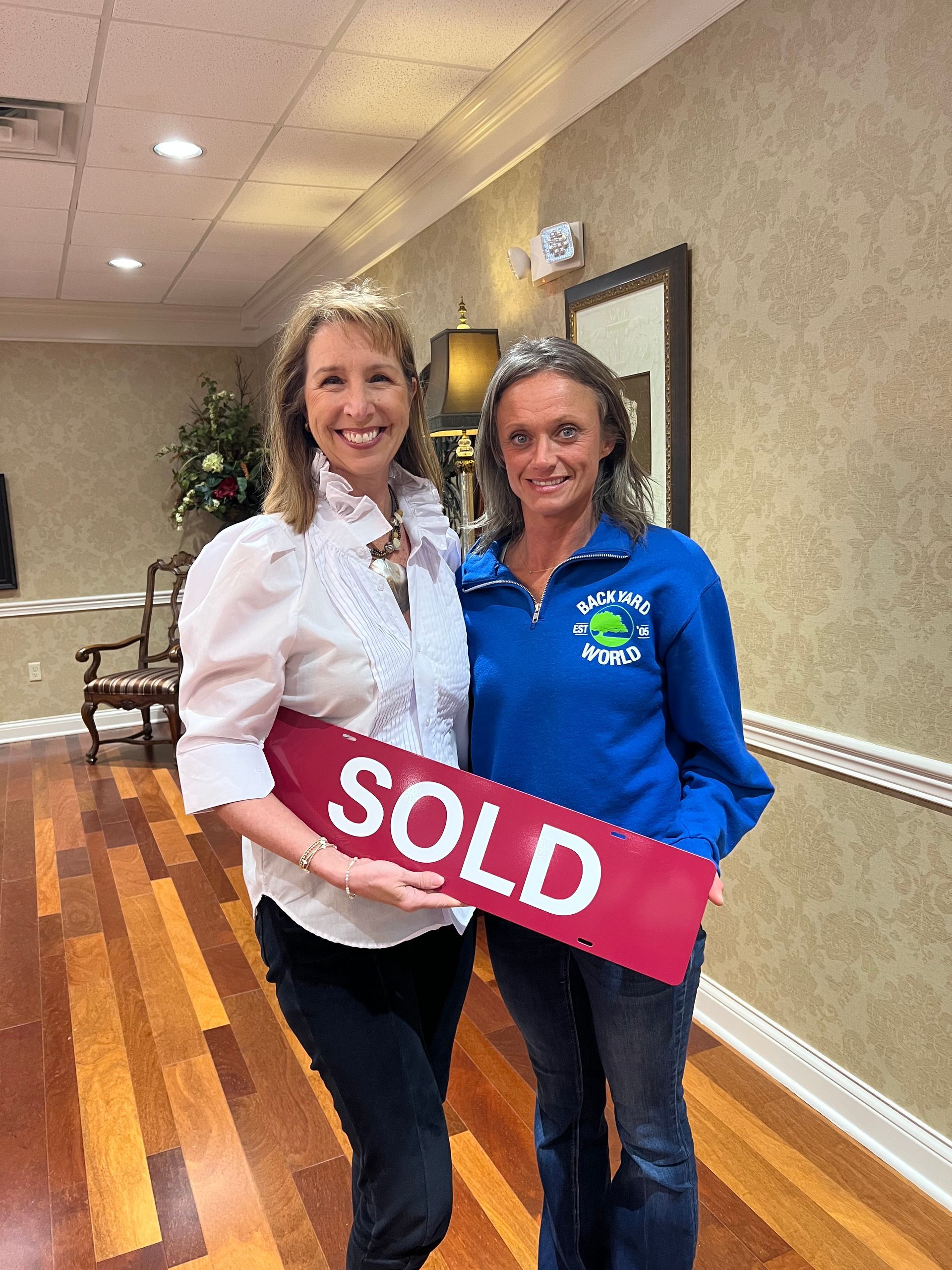 Two smiling people holding a red 