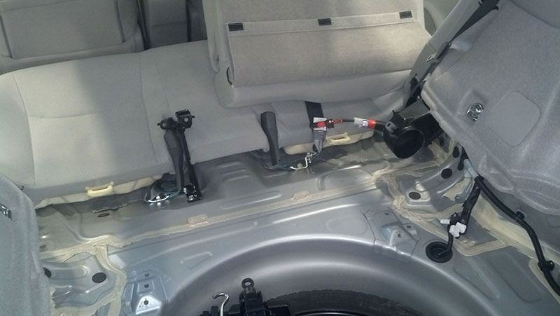 A close up of the trunk of a car with the seats removed | Autotrends