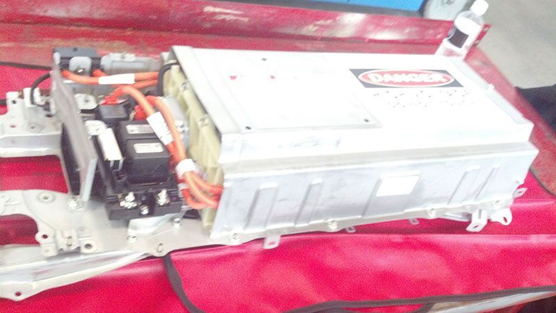 A car battery is sitting on top of a red table | Autotrends