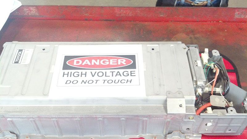 A danger high voltage do not touch sign on a battery | Autotrends