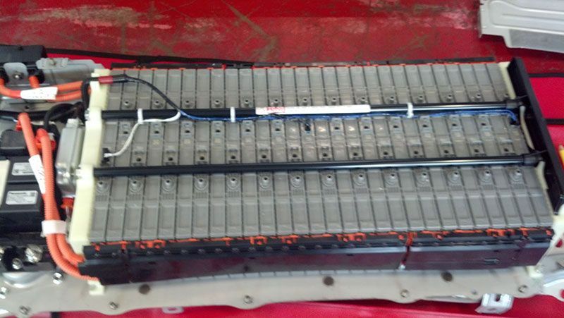 A lithium ion battery is sitting on top of a red table | Autotrends