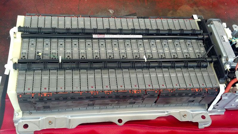 A battery is sitting on top of a red table | Autotrends