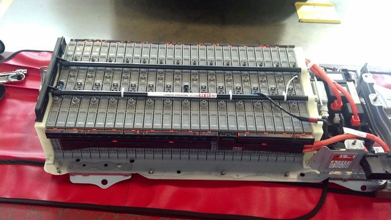 A car battery is sitting on top of a red table | Autotrends