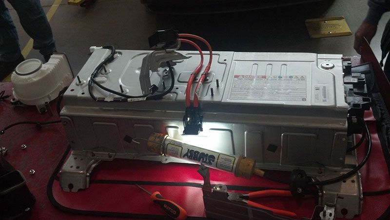 A car battery is sitting on top of a red table | Autotrends