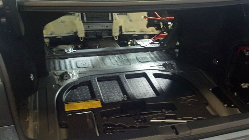 The trunk of a car with a battery in it | Autotrends