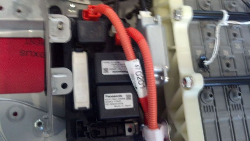 A close up of a car battery with red wires coming out of it | Autotrends