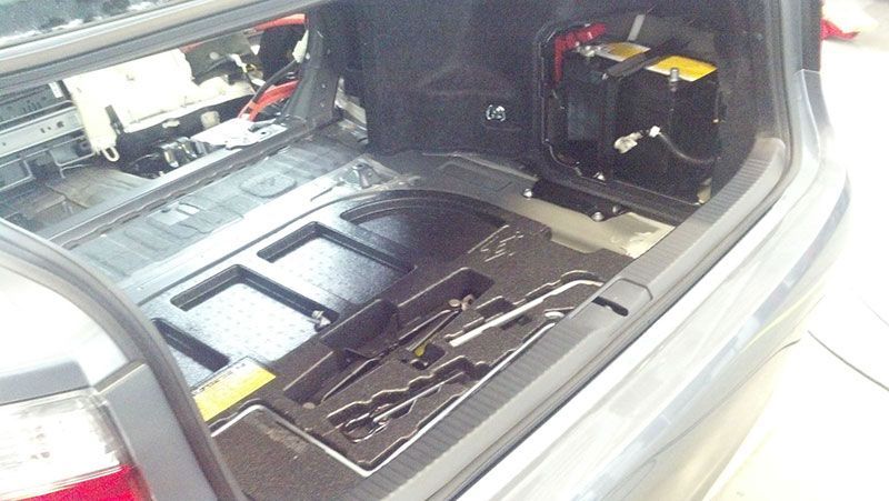 The trunk of a car with a few batteries in it | Autotrends