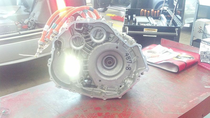 A car engine is sitting on top of a red table | Autotrends