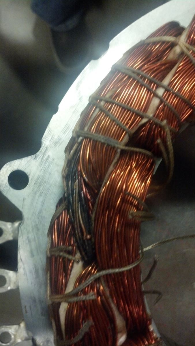 A close up of a copper wire on a metal surface | Autotrends