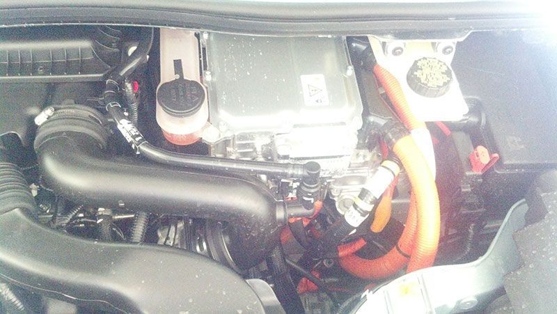 A close up of a car engine with orange wires coming out of it | Autotrends
