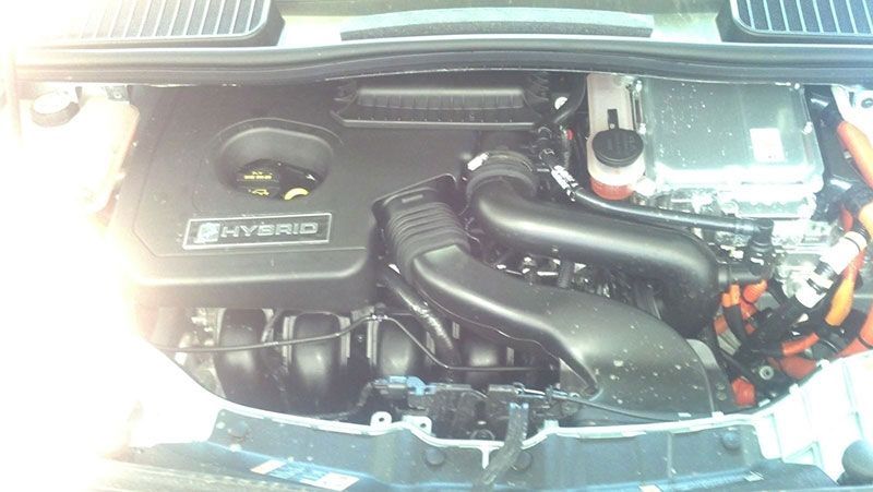 A close up of a car engine with the word hybrid on it | Autotrends