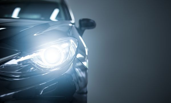 A close up of a car 's headlight on a gray background | Autotrends