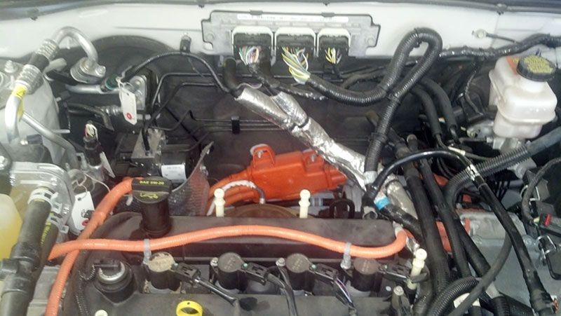 A close up of a car engine with a lot of wires coming out of it | Autotrends