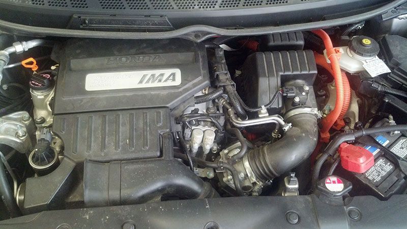 A close up of the engine of a car with the hood open | Autotrends